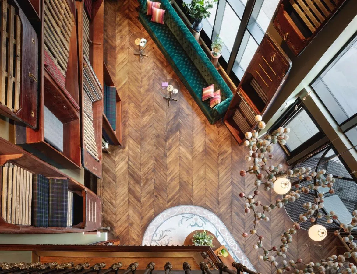 an overhead view of a staircase in a building with wood at Graduate by Hilton Cambridge in Cambridge