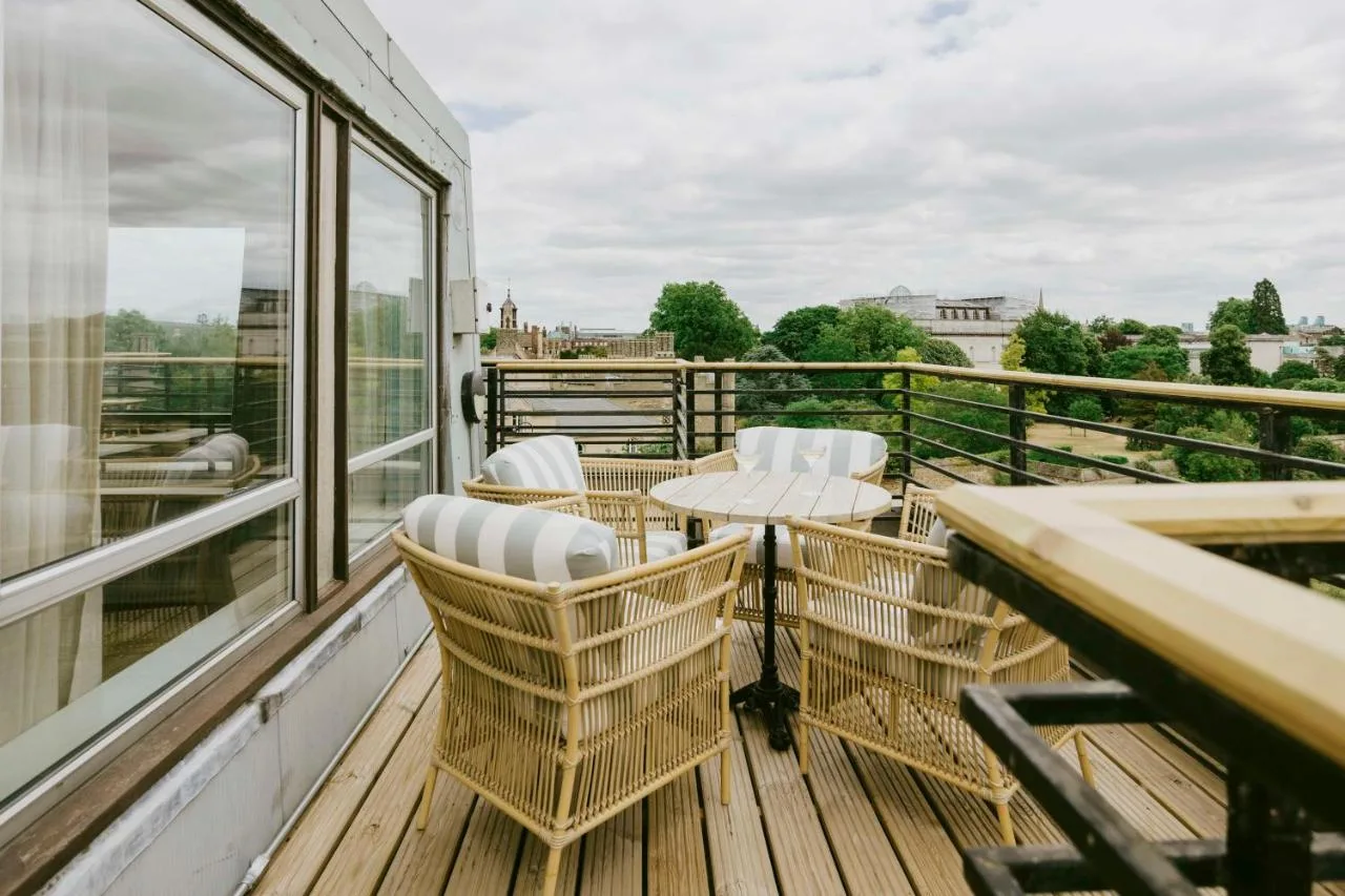 a balcony with chairs and a table and windows at Graduate by Hilton Cambridge in Cambridge