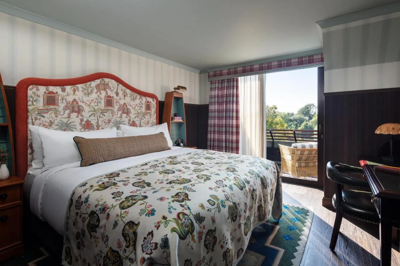 a bedroom with a large bed and a balcony at Graduate by Hilton Cambridge in Cambridge